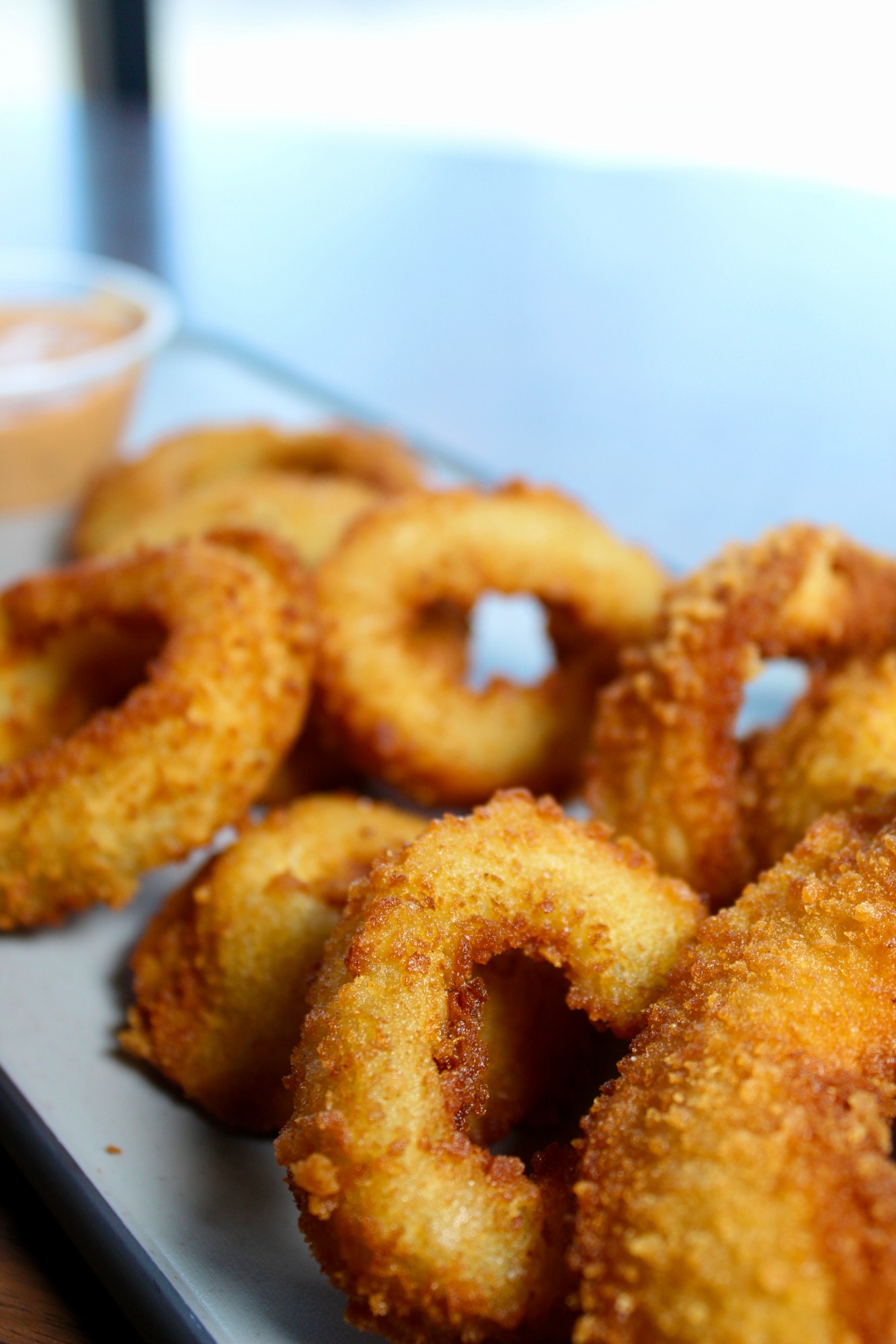 Golden fried onion rings with dipping sauce